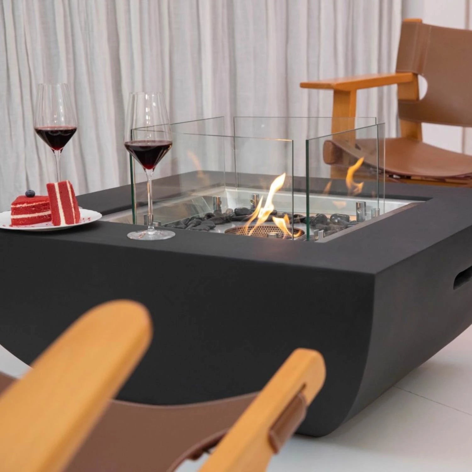 Aurora bioethanol fire pit in matte black with glass windscreen and bronze fire glass